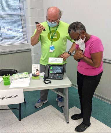 A man assisting a woman with a new phone.