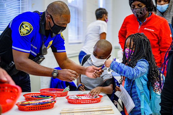 A Police Officer helping children at an event