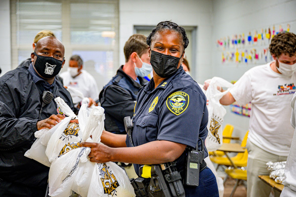 Greenville Police Officers and HACG staff preparing food bags for NNO 2021