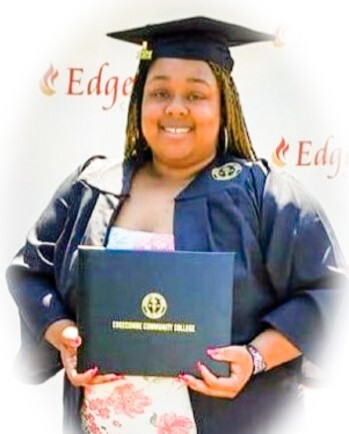A woman holding a diploma.