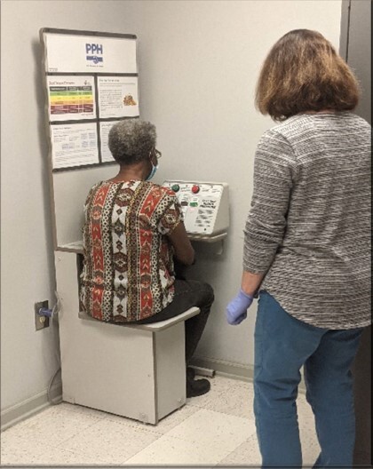 A woman getting her blood pressure checked.