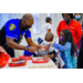 A police officer assisting two children.