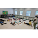 Children laying on the floor and stretching out.
