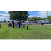 A group of children standing with a rope on the ground in front of them.