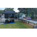 A table full of prizes next to a tent with sound equipment.