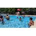 Children swimming at the pool on a sunny day.