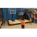 Children playing basketball at an indoor center.