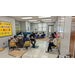 A group of students in a classroom working on assignments.