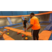 Two boys getting ready to play dodgeball on a trampoline.