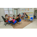 Two ladies in a classroom teaching a group of children. 