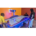 A group of boys playing air hockey.