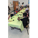 Children at a table painting.