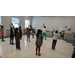 Children in dance class with their arms in the air.