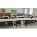 Students at a table sitting in chairs.