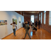 Children and adults exploring an art museum. 