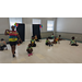 Children stretching out and looking at their teacher during dance class. 