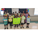 Children holding up a sign and certificates for completing their dance class. 