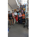 A group of children and adults posing on a staircase. 