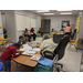 A teacher helping children with their homework at a table. 