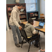 A teacher assisting a student using a laptop. 