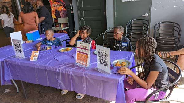 Four children sitting at a table. 